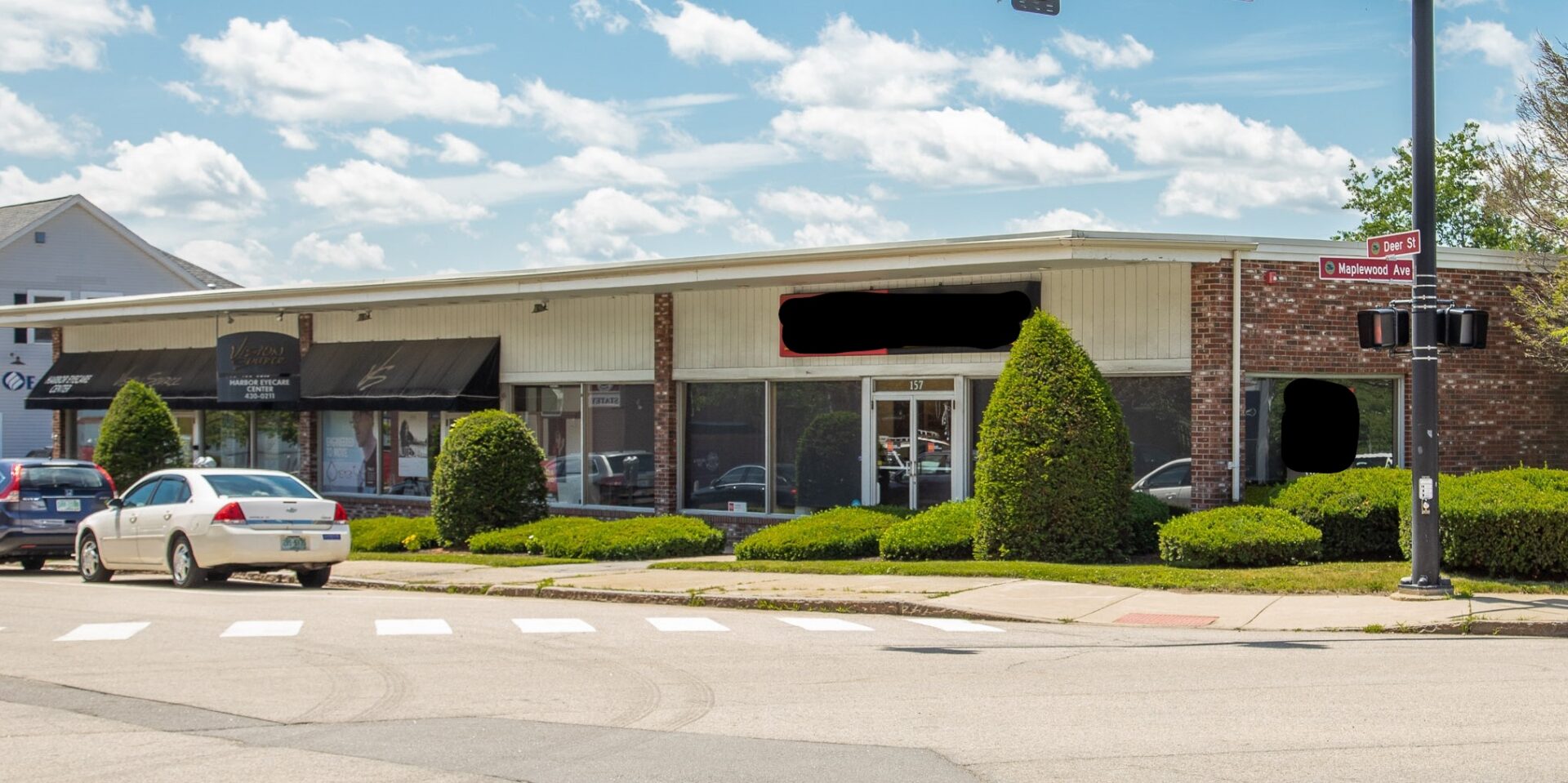 Commercial property for sale at 115 in Springfield, MO 65701, with cars parked in front of it